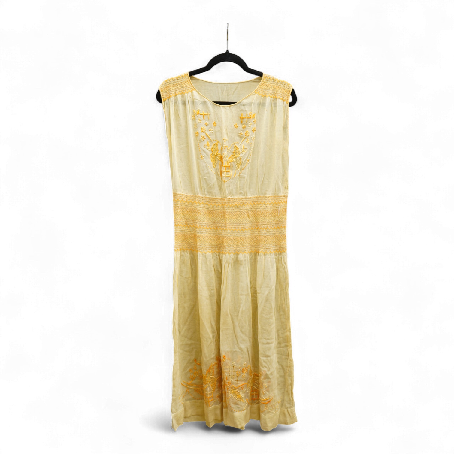 A 1920-30's fine yellow cotton gauze, embroidered and smocked day dress. 117cm long. Condition - good